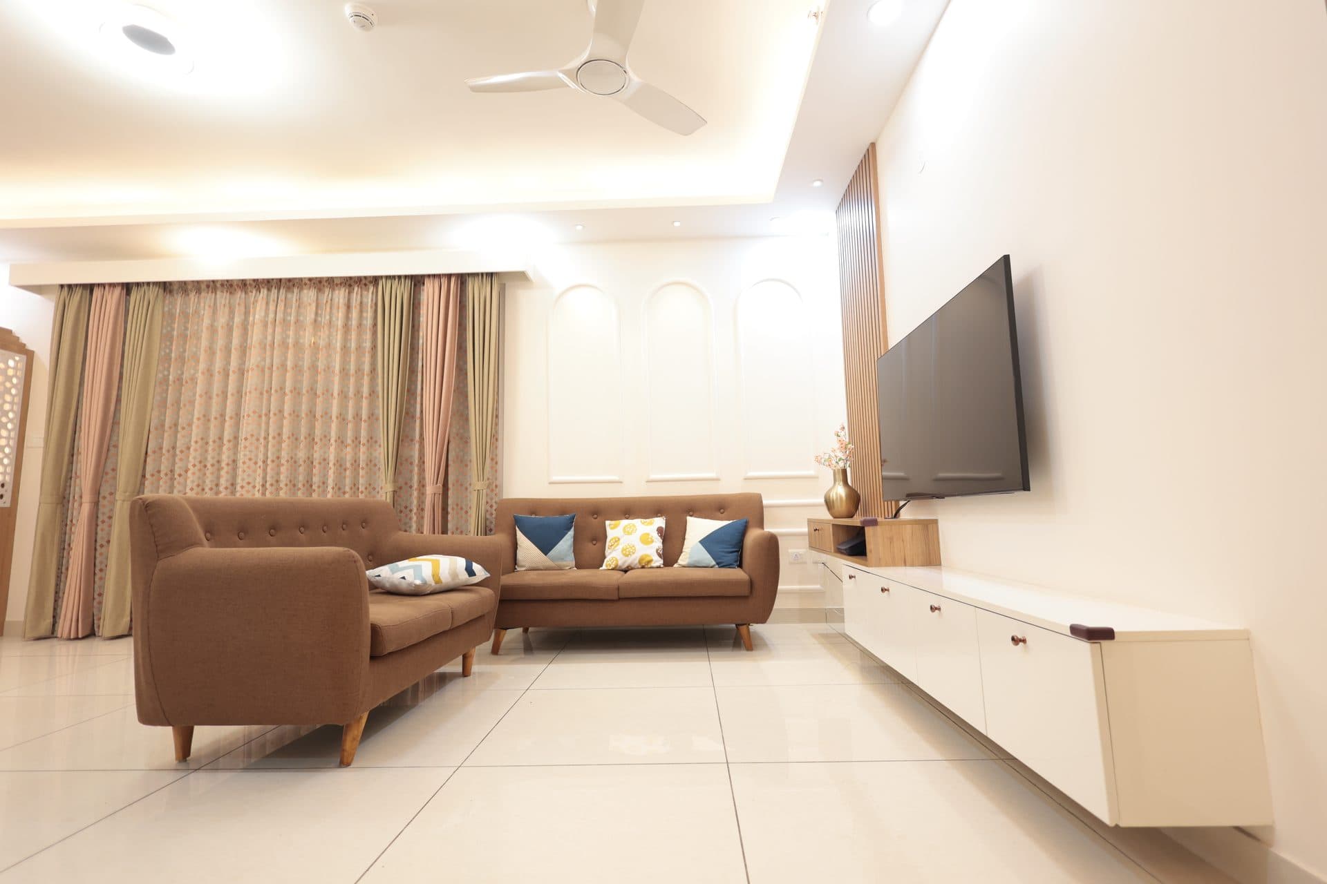 A D'Stella-designed living room with a wood-slat TV wall